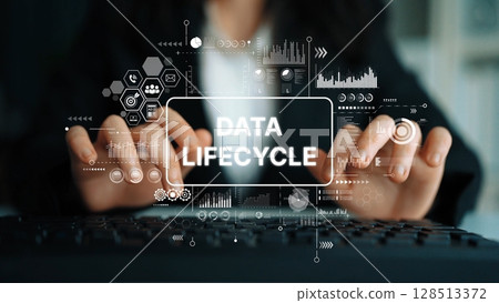 Professional Businesswoman Managing Data Lifecycle Integration in Modern Office Environment with Digital Analytics Graphics. Asymptotic smart data analytic 128513372