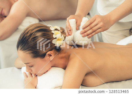 Hot herbal ball spa massage body treatment at day spa . Quiescent 128513465
