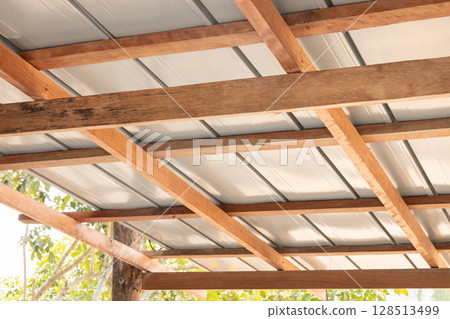 Roof under construction with metal sheet and wood structure. 128513499