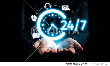 Digital clock illustration representing 24 hour service with glowing icons of communication and support in a dark background featuring a business person hands. Qubit 128513517