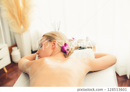 Caucasian woman customer enjoying relaxing anti-stress massage. Quiescent Caucasian woman customer enjoying relaxing anti-stress massage. Quiescent 128513601