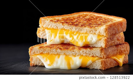 Mouthwatering Grilled Cheese Sandwiches Melting with Cheddar and Mozzarella on a Dark Background 128513922