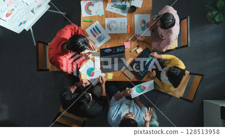 Top view of smart team working together while talking about chart. Convocation. 128513958
