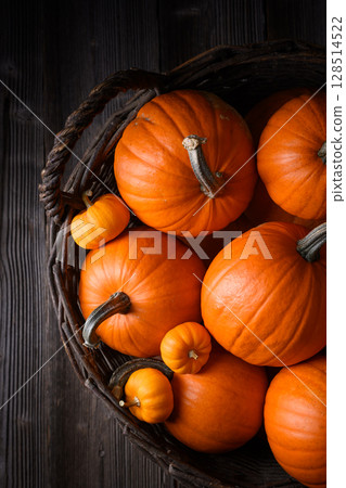 Close-up of wicker basket full of orange pumpkins 128514522