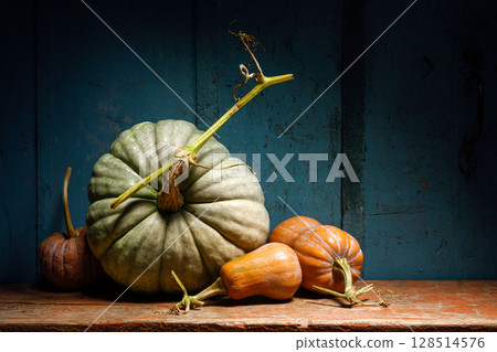 Pumpkin variety decorates old table in warm rustic style Pumpkin variety decorates old table in warm rustic style 128514576