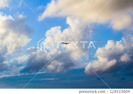 An airplane flying over the sky An airplane flying over the sky 128515604