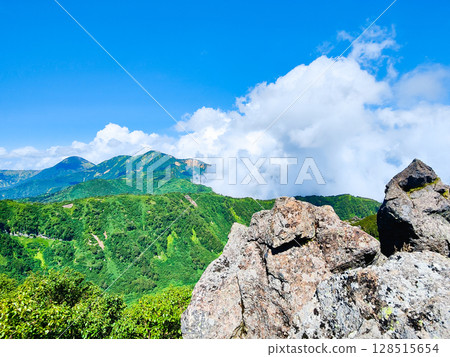 Climbing Mt. Myoko in summer (view of Mt. Yakeyama and Mt. Hiuchiyama from the top of the northern peak) Climbing Mt. Myoko in summer (view of Mt. Yakeyama and Mt. Hiuchiyama from the top of the northern peak) 128515654