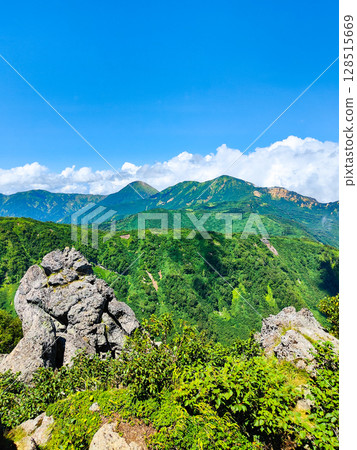 Climbing Mt. Myoko in summer (view of Mt. Yakeyama and Mt. Hiuchiyama from the top of the northern peak) 128515669