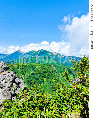 Climbing Mt. Myoko in summer (view of Mt. Yakeyama and Mt. Hiuchiyama from the top of the northern peak) Climbing Mt. Myoko in summer (view of Mt. Yakeyama and Mt. Hiuchiyama from the top of the northern peak) 128515678