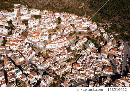 Drone view of the small town with white houses and surrounding countryside, Ojen, Spain in the summer Drone view of the small town with white houses and surrounding countryside, Ojen, Spain in the summer 128516012