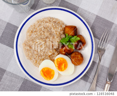 Breakfast with scrumble egg and oatmeal and meatballs closeup Breakfast with scrumble egg and oatmeal and meatballs closeup 128516048