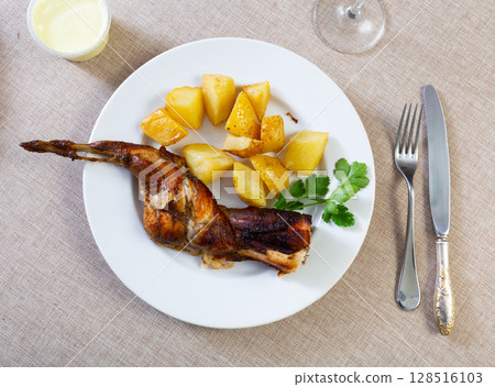 Grilled rabbit served in the plate Grilled rabbit served in the plate 128516103