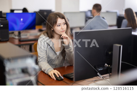 Young woman working on computer in office 128516115