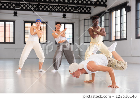 Young man breakdancer doing handstand 128516146