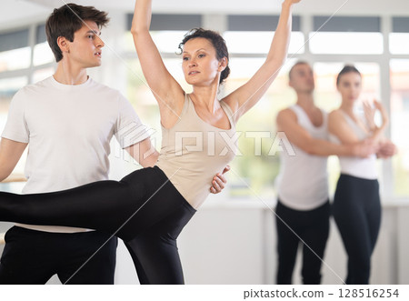 Young guy and adult woman rehearsing pair ballet Young guy and adult woman rehearsing pair ballet 128516254
