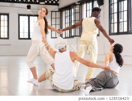 Dancers is doing exercises in class 128516423