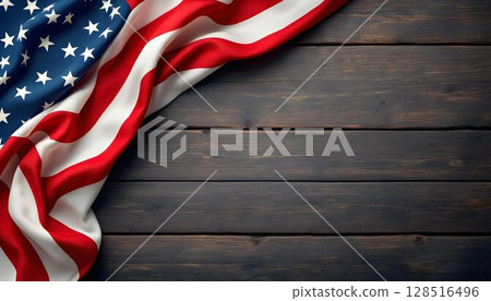 The American flag rests on a wooden background, evoking themes of honor and freedom in remembrance of veterans 128516496