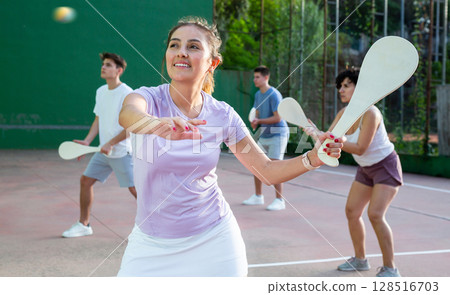 Woman playing Basque pelota on outdoor pelota court Woman playing Basque pelota on outdoor pelota court 128516703