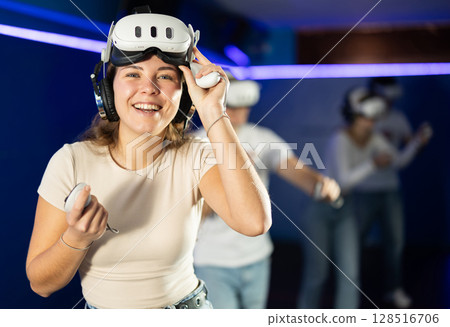 Stunned by exciting game, girl lowered helmet and took break from game. 128516706