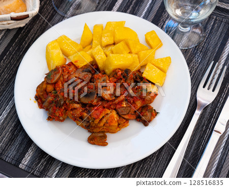 Chicken and mushroom served with french fries. Chicken and mushroom served with french fries. 128516835