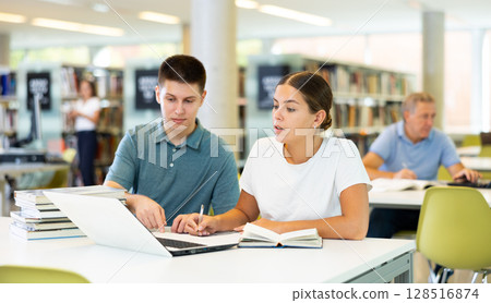 Female college student working on a project with a male student Female college student working on a project with a male student 128516874