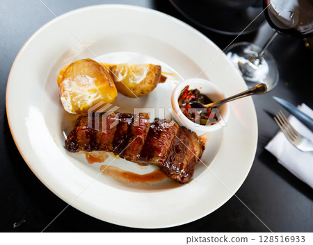 fried veal with French fries and spicy sauce 128516933