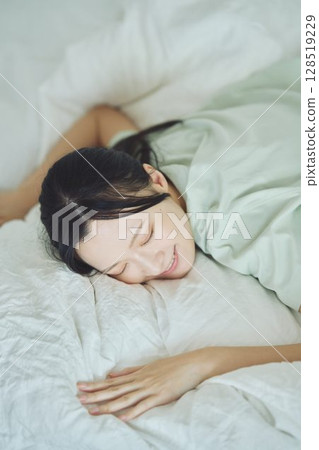 A young lady sleeping in bed A young lady sleeping in bed 128519229