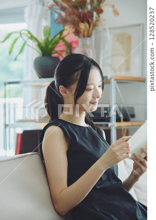 一位女士在客廳裡讀書 128520237