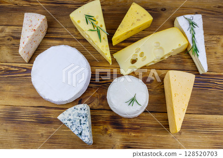 Set of various types of cheese on wooden table. Top view Set of various types of cheese on wooden table. Top view 128520703