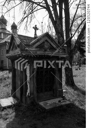 Old stone crypt on the ancient cemetery. Black and white tone Old stone crypt on the ancient cemetery. Black and white tone 128520744