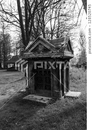 Old stone crypt on the ancient cemetery. Black and white tone Old stone crypt on the ancient cemetery. Black and white tone 128520745