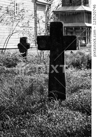 Old stone gravestones in the old abandoned cemetery. Black and white tone 128520746