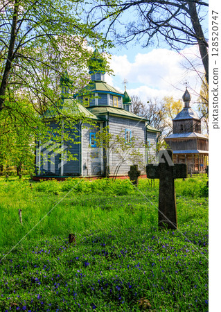 Old wooden church in Open air Museum of Folk Architecture and Folkways of Middle Naddnipryanschina in Pereyaslav, Ukraine 128520747