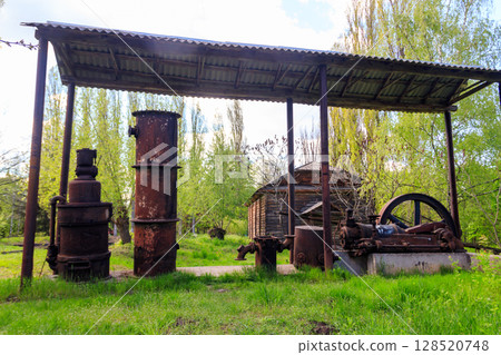 Old steaming threshing machine in Open air Museum of Folk Architecture and Folkways of Middle Naddnipryanschina in Pereyaslav, Ukraine Old steaming threshing machine in Open air Museum of Folk Architecture and Folkways of Middle Naddnipryanschina in Pereyaslav, Ukraine 128520748