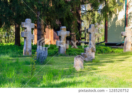 Old stone gravestones in the old abandoned cemetery Old stone gravestones in the old abandoned cemetery 128520752
