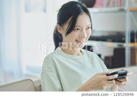 在客廳玩遊戲的女人 128520846