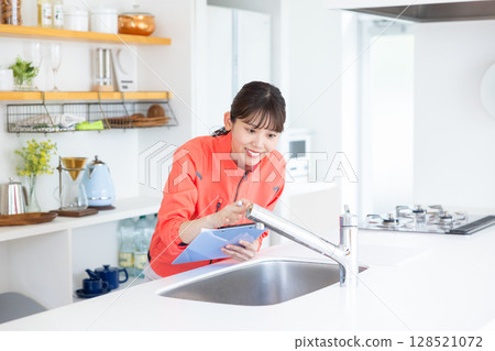 House cleaning staff inspecting the kitchen House cleaning staff inspecting the kitchen 128521072