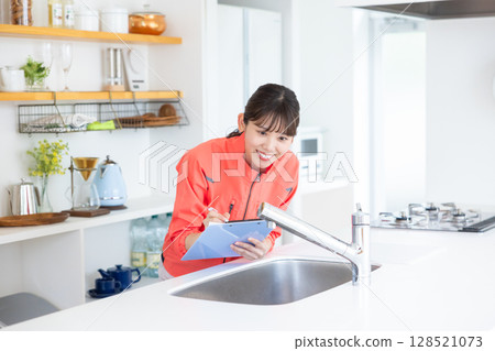 House cleaning staff inspecting the kitchen House cleaning staff inspecting the kitchen 128521073