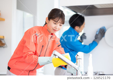 House cleaning staff cleaning the kitchen 128521170