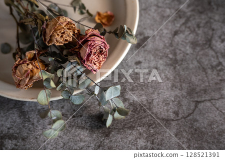 Dried roses and eucalyptus flowers in a container Dried roses and eucalyptus flowers in a container 128521391