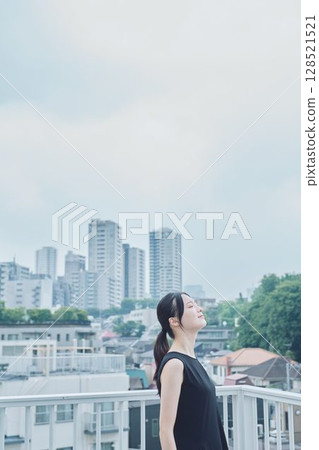 Woman relaxing on balcony 128521521