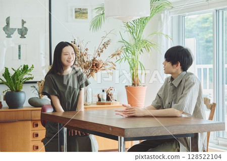 A young couple relaxing in the living room 128522104