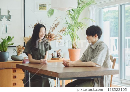 A young couple relaxing in the living room 128522105