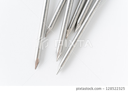 Close-up of the tip of a round nail on a white background 128522325