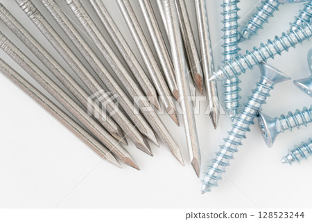 Close-up of round nail and self-tapping screw on white background 128523244