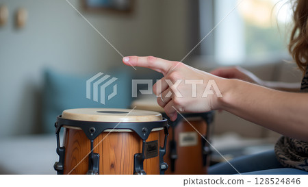 Close up of person playing bongos drums shows musical passion and artistic flair while performing Close up of person playing bongos drums shows musical passion and artistic flair while performing 128524846