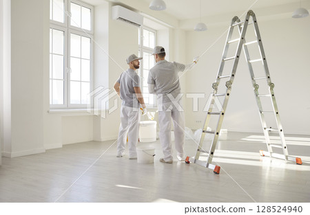 Painters team planning wall painting color, construction workers professional service  128524940