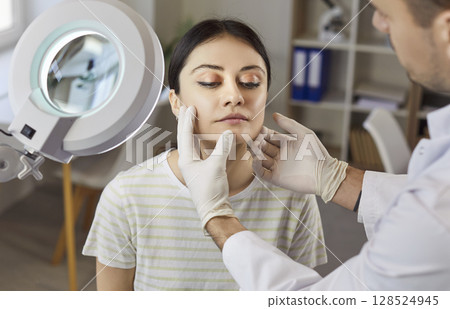 Plastic Surgeon Consulting Patient In Clinic Plastic Surgeon Consulting Patient In Clinic 128524945