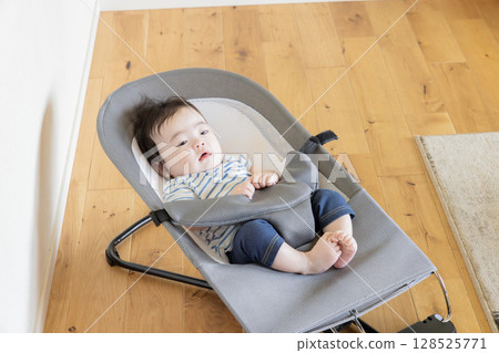 Baby sleeping in a bouncer 128525771