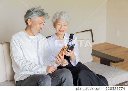 Senior couple searching together on a smartphone 128525774